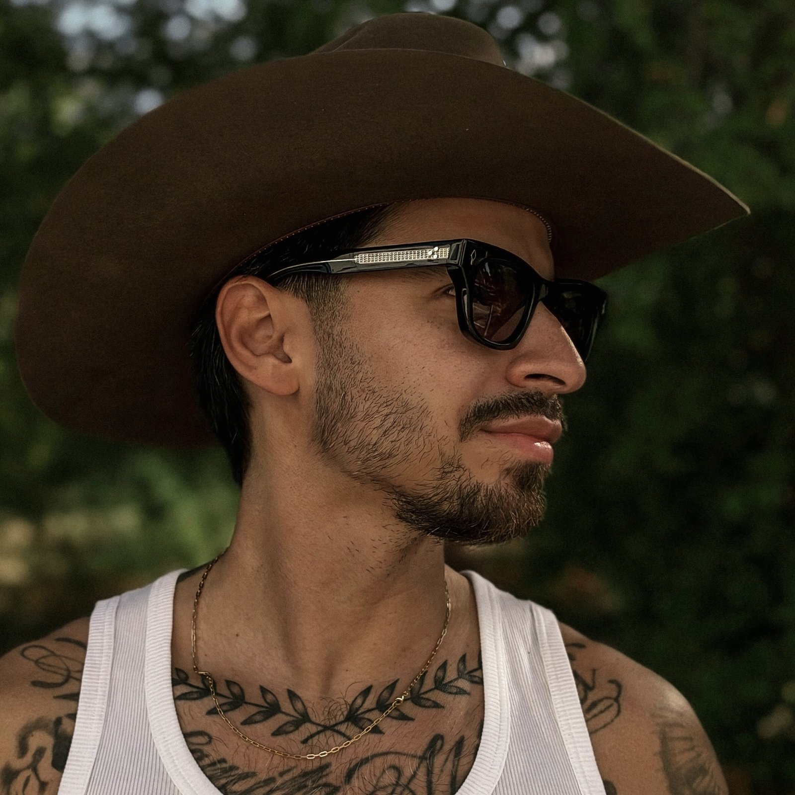 Rob Guevara in a cowboy hat and sunglasses, photographed outdoors in Austin